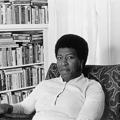 Patti Perret, photograph of Octavia E. Butler seated by her bookcase, 1984. © Patti Perret
