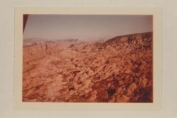 Down Forbidding Canyon; Fifty Mile Mountain at upper left; the Henry Mountains in the haze in the distance; Cummings Mesa at left