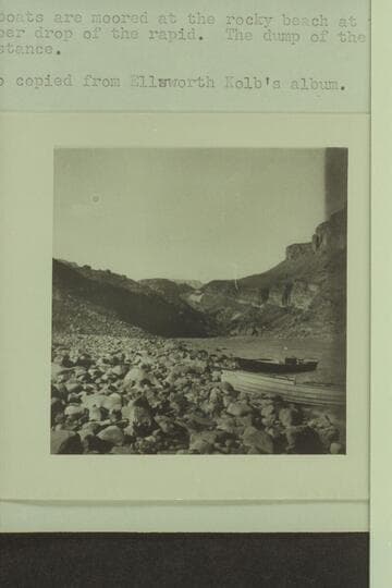 The Kolb boats at Hance Rapid. The boats are moored at the rocky beach at the lower part of the upper drop of the rapid. The dump of the Hance Mine shows in the distance