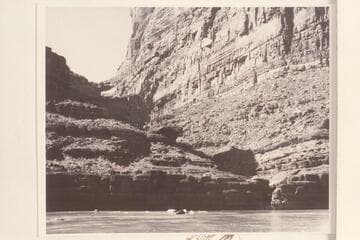 Cove Canyon with boulder in stream course. The head of Powell Puddle has almost submerged the bar at the mouth of the canyon