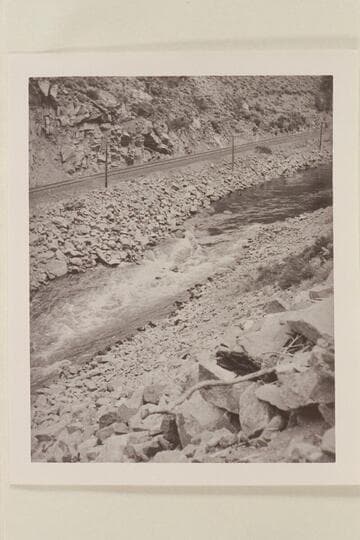 Running a fast flume in Byers Canyon. Harold Leich in his folding kayak "Rob Roy." Leich rolled in Byers Canyon, lined the next rapid as well as the last bad section. He was one hour and 20 minutes through Byers Canyon and made 27-28 miles for the day
