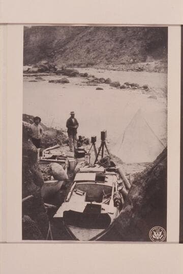 The boats as they were cached below Badger Creek Rapid. The "Titanic" in the foreground and the Ross Wheeler on the left. Quist stands at the left