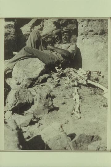 Bill Davis posing with the skeleton near Vaseys Paradise. Mile 31 1/2 Marble Canyon. The Sheriff had investigated the skeleton a dn Dr. Hume rearranged the bones in order when he visited here in 1952