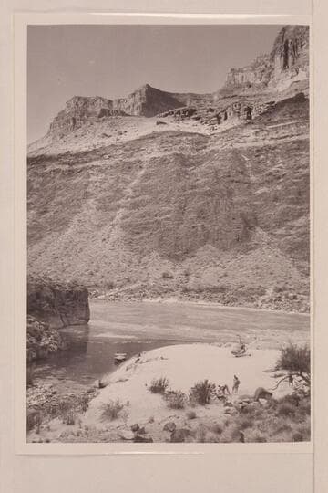 The motorboat "Hudson" in the lagoon and the helicopter on the beach at the mouth of Tapeats Creek in the Grand Canyon. Camp groups include: Margaret Marston, "Red" Carson, Joe Desloge, Willie Taylor, Bill Belknap and Guy Forcier