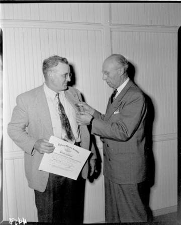Man receiving life saving medal from EEI