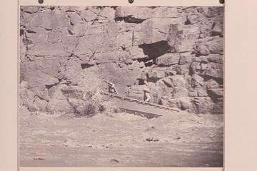 A single motored 18 foot aluminum hull running one of Grand Canyon's rapids. The power unit was 25HP