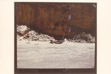 Georgie White's pontoon rig in Dark Canyon Rapid. The print is reversed
