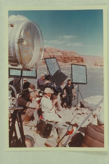 Disney camera crew at Idas Riffle. Filming of "The Colorado River Story." Bert Lynch, still camerman sits center. Bill Beaudeen, director, sights the camera