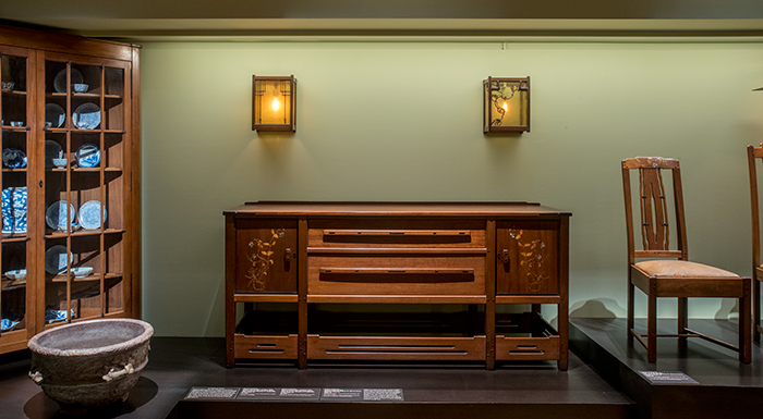 The sideboard and side chair from the 1909 Thorsen house in Berkeley, Calif. with above them two wall lanterns made for the 1902 James A. Culbertson house.